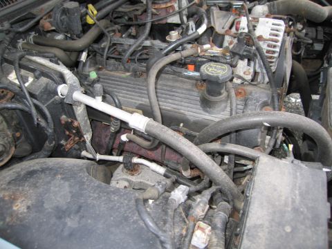 1991 Ford LTD Crown Victoria - Close-up view of a car's engine bay, showing various components and wiring.