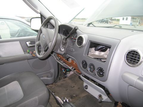 1991 Ford LTD Crown Victoria - The interior of a Ford SUV shows a disassembled dashboard with exposed wiring and components.