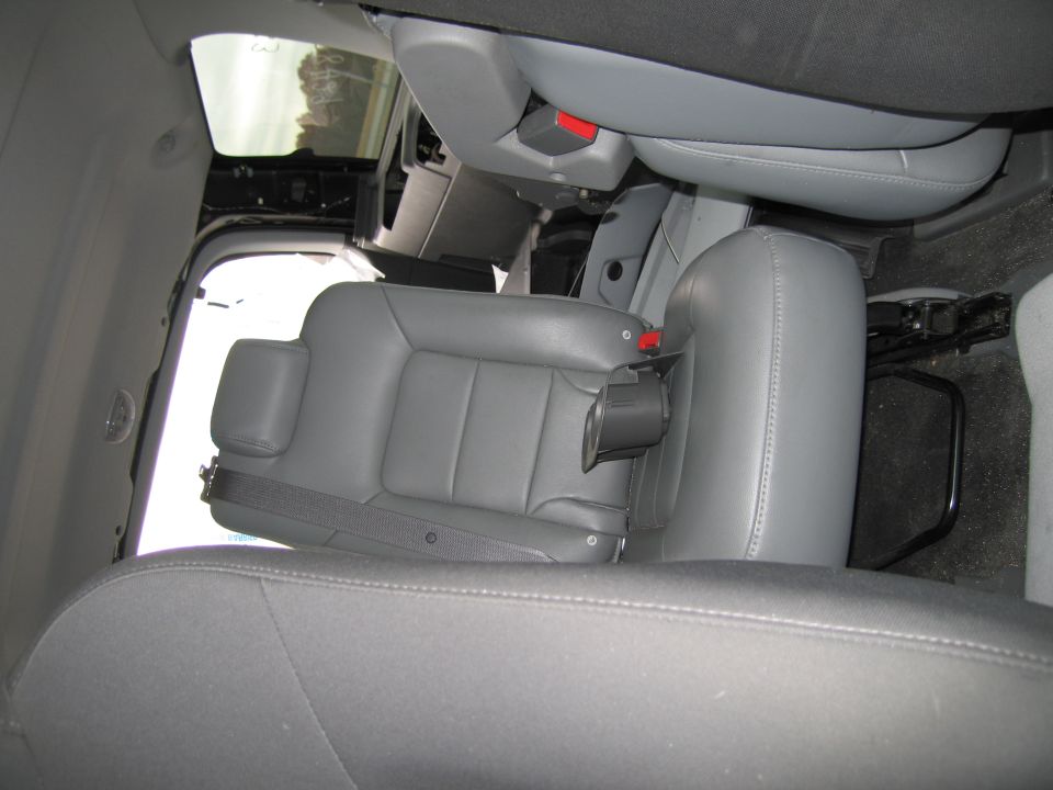 Interior shot of gray leather seats and seatbelts in a vehicle