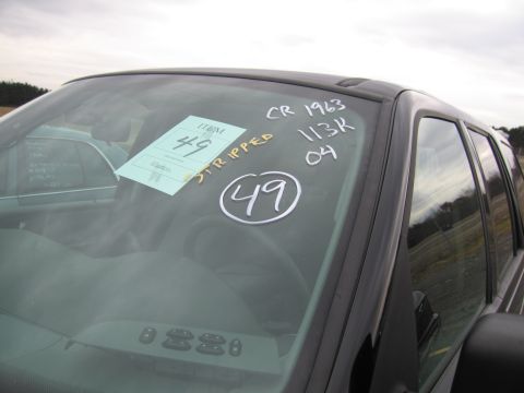1991 Ford LTD Crown Victoria - Windshield of a car with an item tag and handwritten notes, with another vehicle in the background.