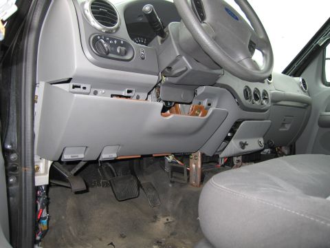 1991 Ford LTD Crown Victoria - Interior view of a car with the dashboard partially removed, revealing wiring and pedals.