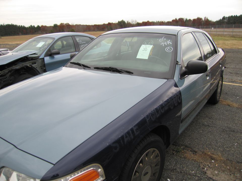 Police car with 'STATE POLICE' on fender, another car in background