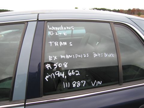 1991 Ford LTD Crown Victoria - Handwritten notes on a car's side window detail its condition and VIN.