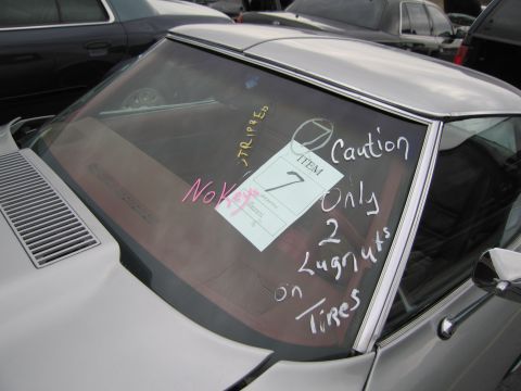 1991 Ford LTD Crown Victoria - A car's windshield displays handwritten notes, including 'No Keys' and 'Caution Only 2 Lugnuts on Tires'.