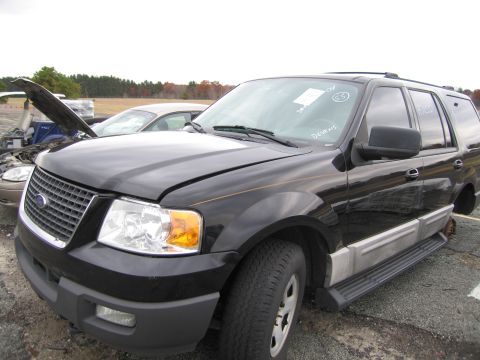 1991 Ford LTD Crown Victoria - A black Ford Expedition SUV is parked in a lot with its hood open, next to another vehicle.