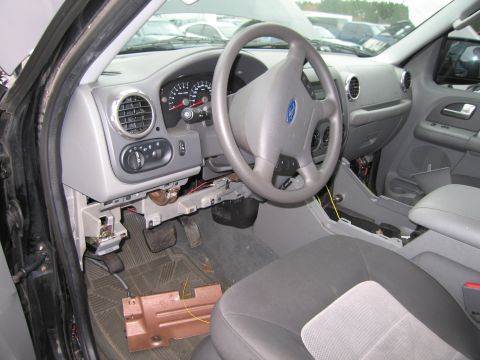 1991 Ford LTD Crown Victoria - Interior view of a car with the dashboard and steering wheel exposed, showing some disarray.