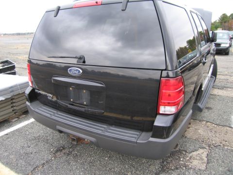 1991 Ford LTD Crown Victoria - Rear view of a black Ford Expedition, showing its taillights and rear bumper.