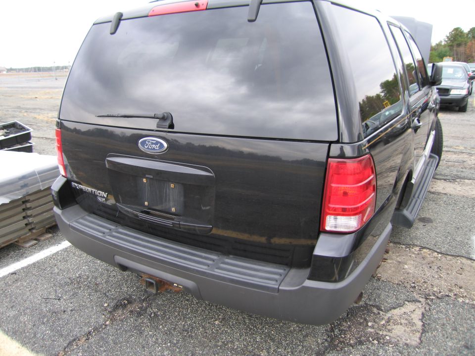 Black Ford Expedition rear view with 'EXPEDITION' badge visible