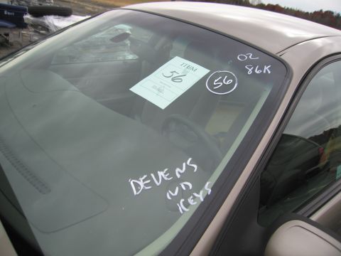 1991 Ford LTD Crown Victoria - Interior view of a car with item tags and handwritten notes on the windshield.