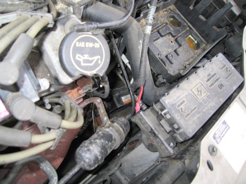 1991 Ford LTD Crown Victoria - Close-up view of an engine bay, showing the oil cap and a fuse box with some wiring.