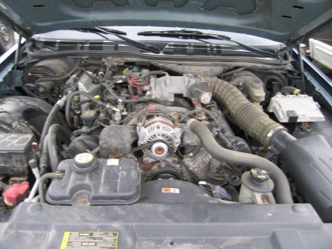 1991 Ford LTD Crown Victoria - The engine bay of a Ford Crown Victoria is shown with the hood open, revealing the V8 engine and various components.