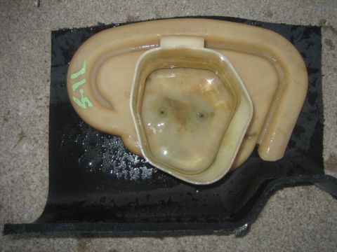 1996 Ford Thunderbird - Plastic automotive part with green markings '71-5' on a black mat.