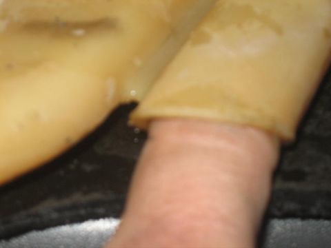 1996 Ford Thunderbird - A finger touches a tan-colored car part, likely interior trim, in this close-up shot.