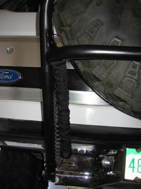 1995 Ford Bronco - Close-up of the rear of a 1995 Ford Bronco, highlighting the spare tire carrier and bumper assembly.