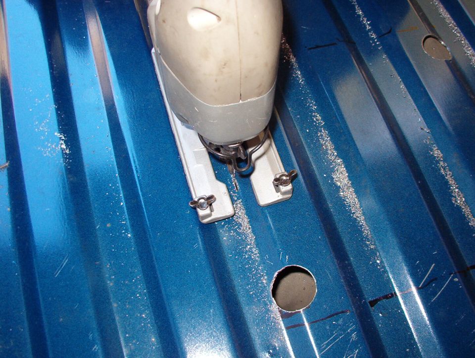 Be aware of the distance from the floor to the tank at all times, and remember that the fuel lines, pump wiring, and vent hose are in there.

A slitting chisel in an air hammer is a FAR-BETTER way to cut the hole, and doesn't require any prep.