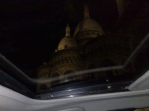 1991 Ford Crown Victoria - View through a sunroof at night, reflecting a large domed building.