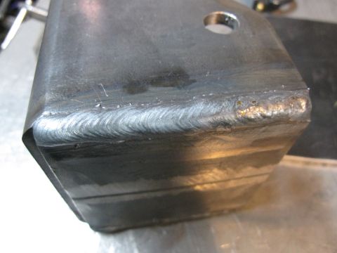 1996 Ford Bronco - Close-up of a metal bracket showing extensive welding marks and a circular hole.