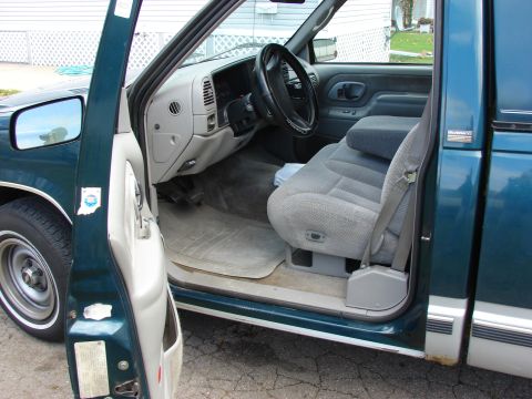 1984 Ford F-250 - Interior view of a pickup truck with the driver's door open.