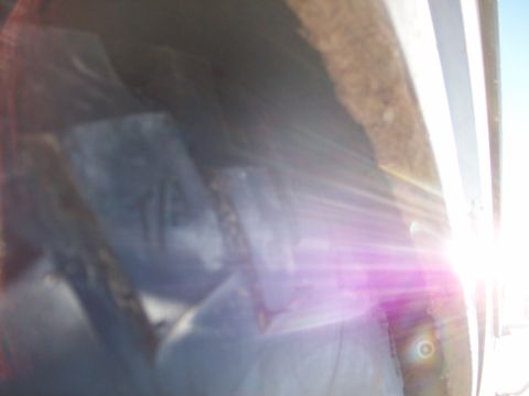 1985 Ford Bronco - Sunlight flares across the interior of a vehicle, obscuring details of the dashboard.