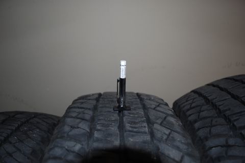 2000 Land Rover Range Rover - A tire tread depth gauge is shown measuring the tread on a tire.