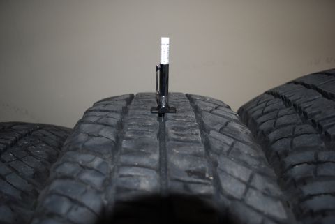2000 Land Rover Range Rover - A tread depth gauge is used to measure the tire tread on multiple tires.