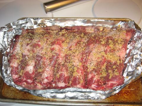 1978 Ford Bronco - Seasoned raw ribs are prepared for cooking on a foil-lined baking sheet.
