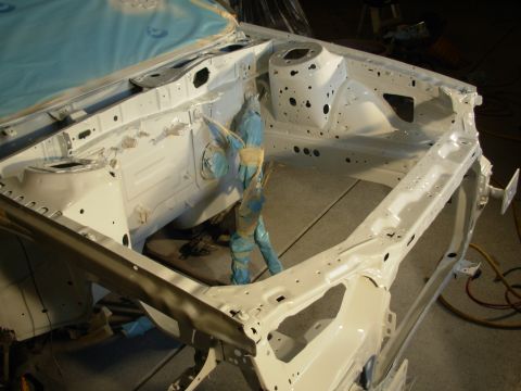 1991 Ford Taurus - Engine bay frame being prepped for paint, with blue protective coverings in place.