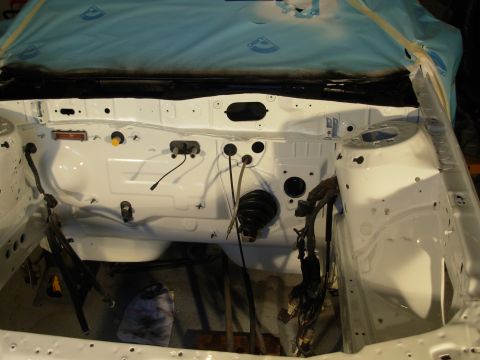 1991 Ford Taurus - Engine bay being prepped for rebuild, showing fresh white paint and exposed wiring.
