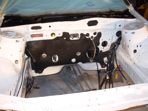 1991 Ford Taurus - Engine bay stripped down for restoration work, revealing the firewall and structural components.