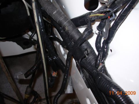 1991 Ford Taurus - Close-up view of a complex engine wiring harness, showing various bundles of wires taped together.