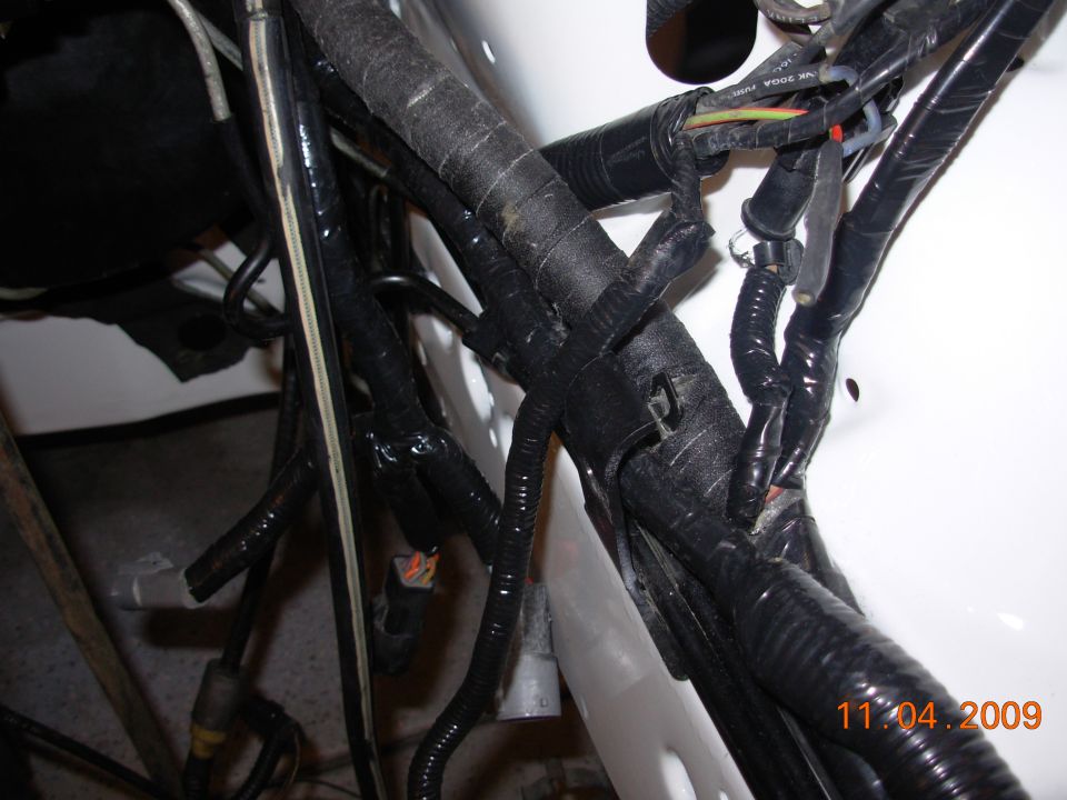 Engine wiring harness with black tape and connectors