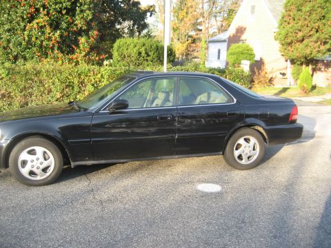 1997 Acura TL - Side profile of a black 1997 Acura TL sedan parked on a residential street.