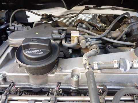 2003 Volkswagen Beetle - Close-up view of the engine bay in a 2003 Volkswagen Beetle, highlighting mechanical components and wiring.