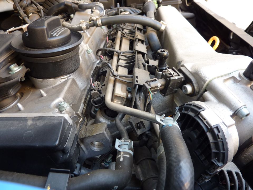 Close-up of a Volkswagen engine bay with fuel injectors and hoses visible