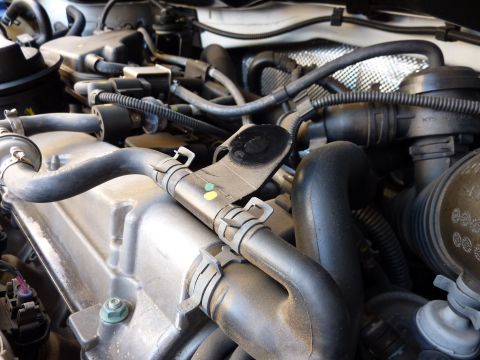 2003 Volkswagen Beetle - Close-up view of an engine bay, showing various hoses and mechanical parts.