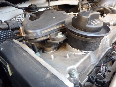 2003 Volkswagen Beetle - Close-up of an engine oil cap and associated engine parts.