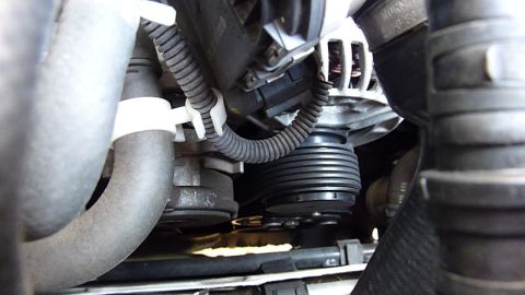 2003 Volkswagen Beetle - Close-up view of an engine's belt and pulley system, showing the ribbed pulley and surrounding components.