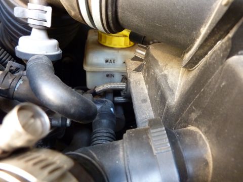 2003 Volkswagen Beetle - The brake fluid reservoir shows MIN and MAX fill lines, indicating a mechanical component within the engine bay.