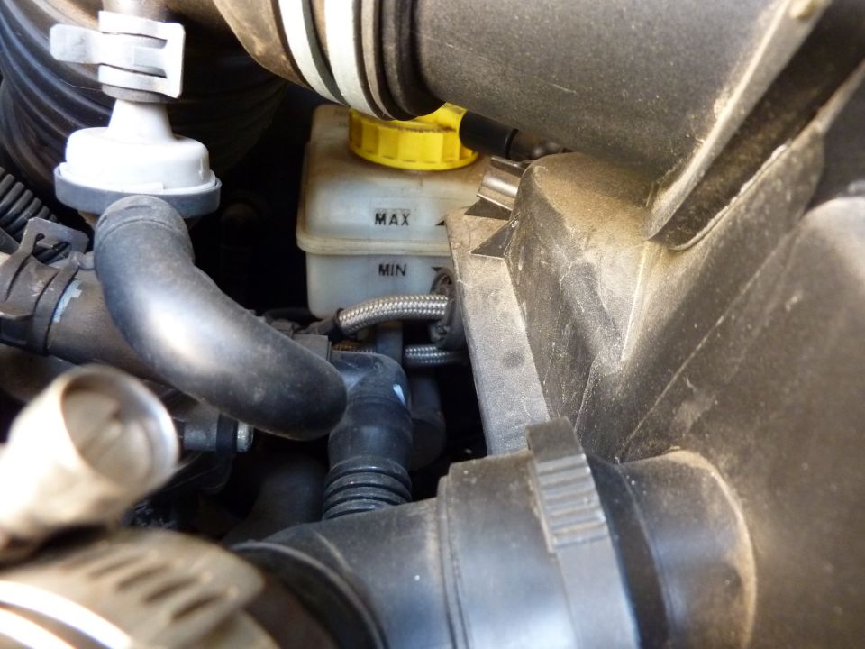 Close-up of brake fluid reservoir with MAX and MIN markings