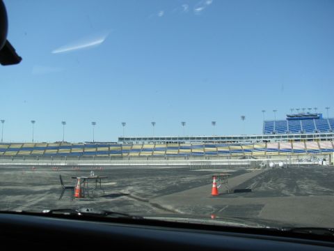 2003 Mercury Marauder - A clear day at the racetrack, with empty stands and cones marking the course.