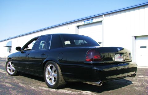 2003 Mercury Marauder - Rear view of a black 2003 Mercury Marauder sedan with chrome wheels and tinted taillights.