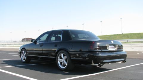 2003 Mercury Marauder - A black 2003 Mercury Marauder is parked in a lot with a clear sky overhead.