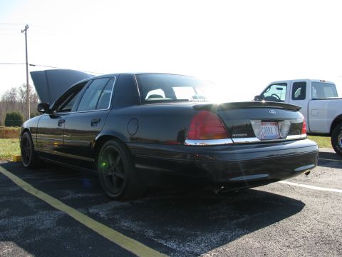 2003 Mercury Marauder - A black 2003 Mercury Marauder is parked with its hood open, showing its rear end and aftermarket wheels.