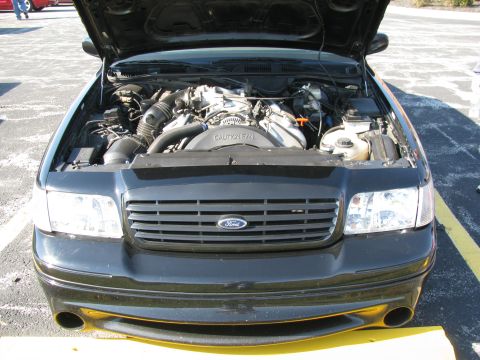 2003 Mercury Marauder - Front view of a black 2003 Mercury Marauder with its hood open, revealing the engine compartment.