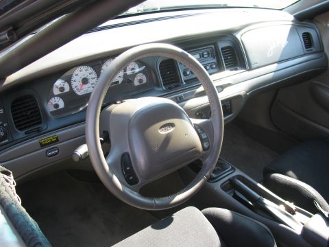 2003 Mercury Marauder - The interior of a car shows the dashboard, steering wheel, and center console with gauges.
