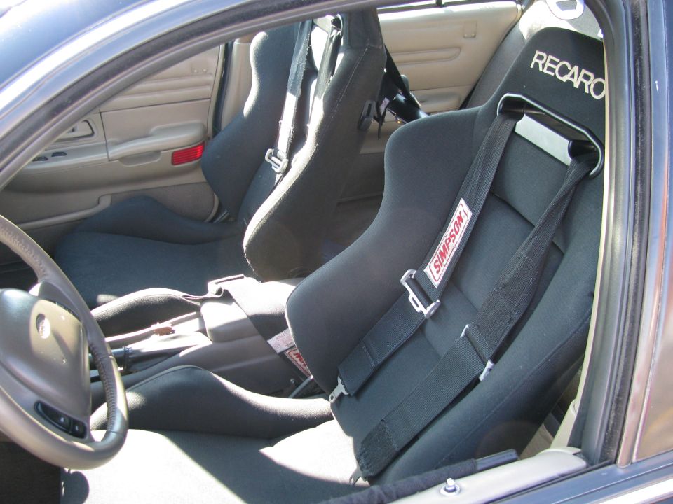 Car interior with black Recaro racing seats and Simpson harnesses