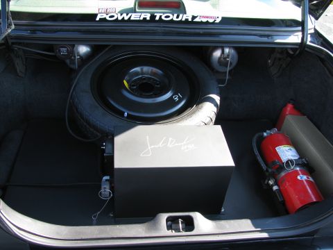 2003 Mercury Marauder - Trunk contents include a spare tire, amplifier, and fire extinguisher, with a 'Hot Rod Power Tour 2009' sticker visible.