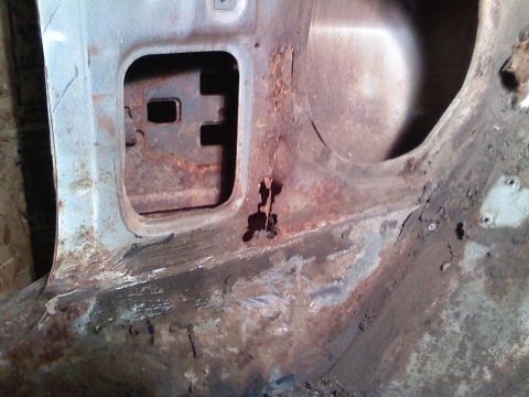 1969 Ford Mustang - This photo shows significant rust damage on a car's door frame, obscuring any model year details.