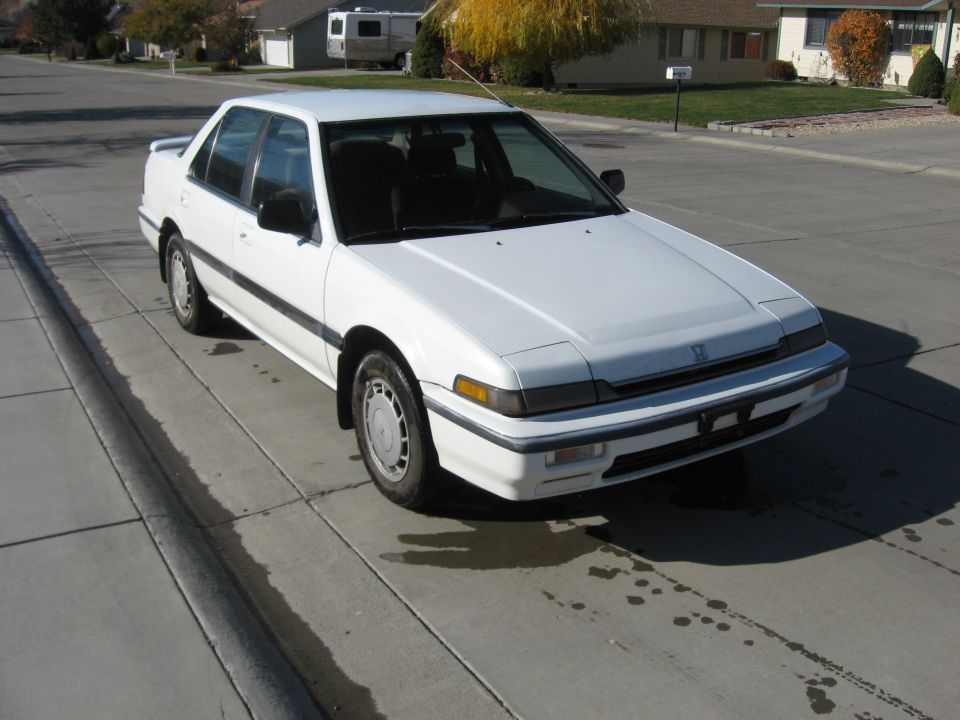 1989 Honda Accord sedan parked on concrete driveway, front quarter view