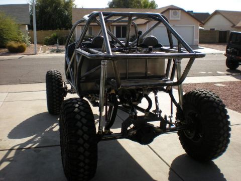 2009 Suzuki Samurai - Custom tube chassis buggy with large off-road tires parked in a driveway.